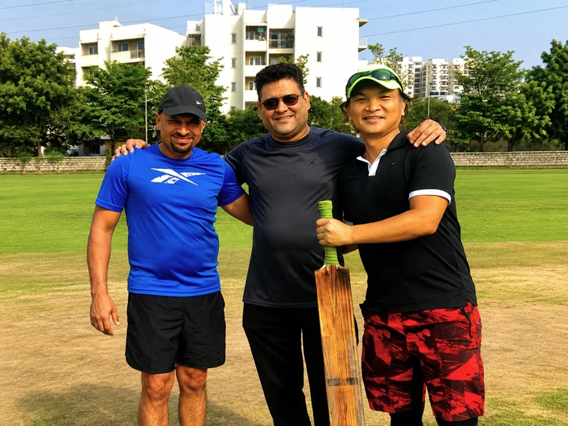 Three Ripplrites with a bat on the cricket ground
